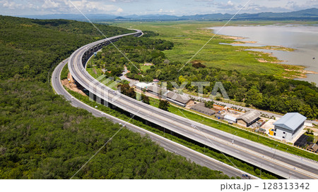 Drone shot The M6 motorway Nakhon Ratchasima Province - Bang Pa-in Lam Ta Khong River and Mountain. Motorway Korat Thailand Drone shot The M6 motorway Nakhon Ratchasima Province - Bang Pa-in Lam Ta Khong River and Mountain. Motorway Korat Thailand 128313342