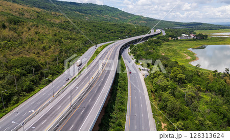Drone shot The M6 motorway Nakhon Ratchasima Province - Bang Pa-in Lam Ta Khong River and Mountain. Motorway Korat Thailand Drone shot The M6 motorway Nakhon Ratchasima Province - Bang Pa-in Lam Ta Khong River and Mountain. Motorway Korat Thailand 128313624