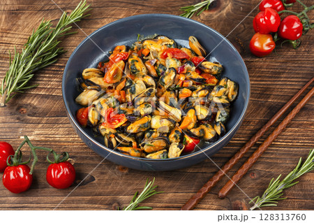 Plate of mussels on a table. Plate of mussels on a table. 128313760