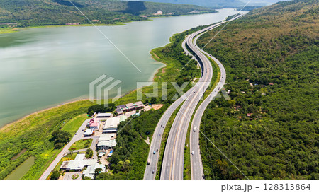 Drone shot The M6 motorway Nakhon Ratchasima Province - Bang Pa-in Lam Ta Khong River and Mountain. Motorway Korat Thailand Drone shot The M6 motorway Nakhon Ratchasima Province - Bang Pa-in Lam Ta Khong River and Mountain. Motorway Korat Thailand 128313864