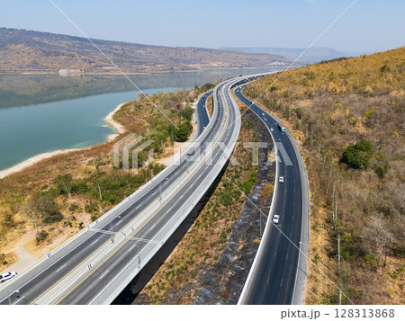 Drone shot aerial view landscape of the M6 motorway Expressway Nakhon Ratchasima Province - Bang Pa-in. Lam Ta Khong River and Mountain. Drone shot of scenic landscape rural place traffic. Nakhon Drone shot aerial view landscape of the M6 motorway Expressway Nakhon Ratchasima Province - Bang Pa-in. Lam Ta Khong River and Mountain. Drone shot of scenic landscape rural place traffic. Nakhon 128313868