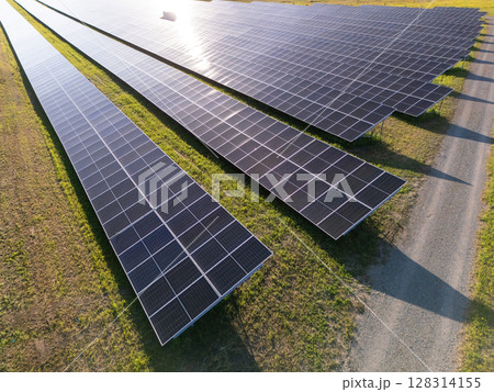 Aerial view of solar power station on a green field. Sustainable development. 128314155
