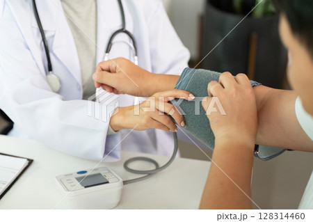 Healthcare. Nurse measuring blood pressure of patient. 128314460