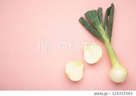 Green onion on pink background. Macro photo Green onion on pink background. Macro photo 128315563