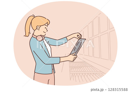 Woman stands in music store and looks at vinyl record of rare acoustic concert by favorite band 128315588