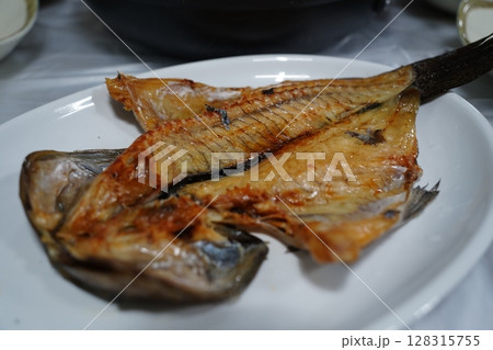 Grilled Mackerel Fish Served on White Plate in Restaurant 128315755
