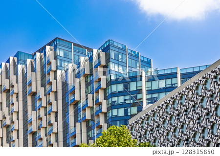 Contemporary glass apartment towers with geometric fins 128315850