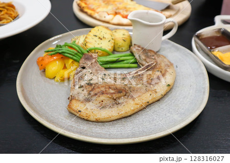 pork steak or grilled pork and salad or pork chop pork steak or grilled pork and salad or pork chop 128316027