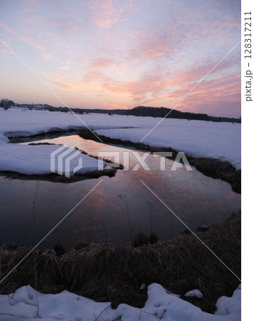 A river with a reflection of the sky in the water 128317211