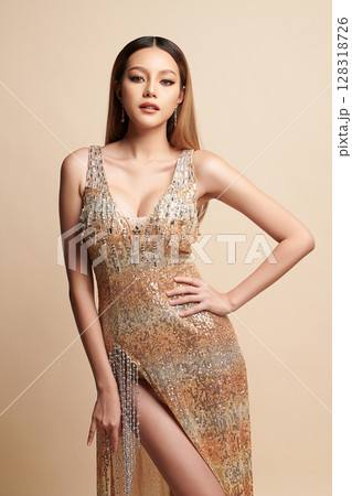 Beautiful young asian woman, with gold Dress, Elegant Woman in Sexy Evening Gown, Beautiful on beige Background, Beautiful young asian woman, with gold Dress, Elegant Woman in Sexy Evening Gown, Beautiful on beige Background, 128318726