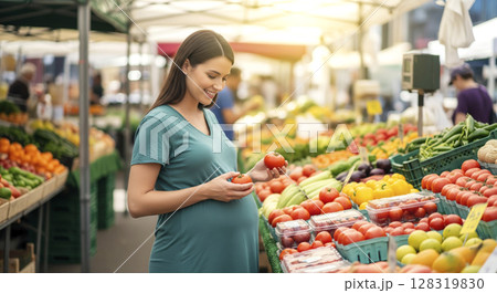 Smiling pregnant woman selects fresh produce at market, embracing healthy eating and maternal wellness. 128319830