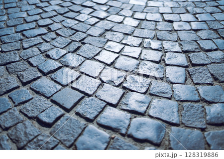 Close-Up Texture of Curved Stone Cobblestone Pavement in Blue Tone 128319886