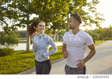 Happy sporty friendly people actively running outdoors, healthy looking couple jogging enjoying Happy sporty friendly people actively running outdoors, healthy looking couple jogging enjoying 128320185