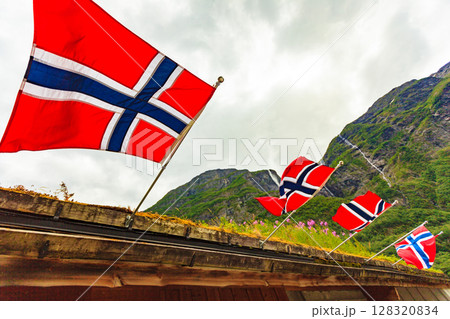 norwegian flags on green mountains background norwegian flags on green mountains background 128320834