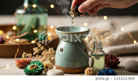 Hand Adding Essential Oil to Boho Diffuser Hand Adding Essential Oil to Boho Diffuser 128322364