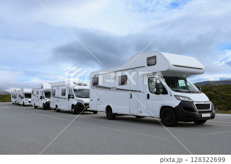 Campers parked on a caravan park. Motorhomes and camping cars for traveling 128322699