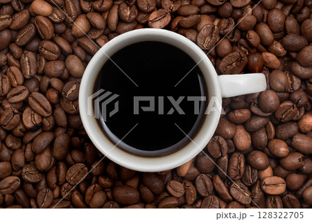 A cup of aromatic coffee against the background of coffee beans. 128322705
