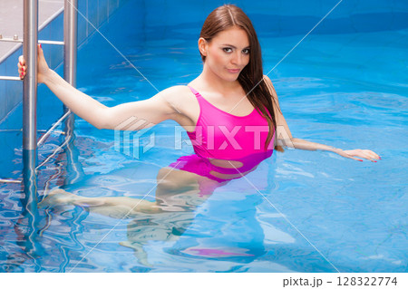 Woman having fun in swimming pool 128322774