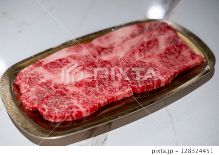 Raw Sliced Hanwoo Beef, marbled Korean Style Meat prepared on the golden plate 128324451