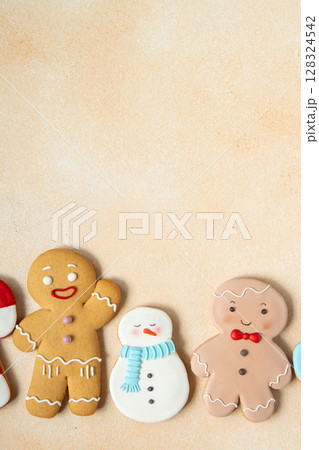 Gingerbread cookies with icing decoration. Christmas food. Gingerbread men and snowman. Top view table. Xmas sweet copy space background. Gingerbread cookies with icing decoration. Christmas food. Gingerbread men and snowman. Top view table. Xmas sweet copy space background. 128324542