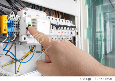 Hand Operating Switch on Electrical Panel 128324696