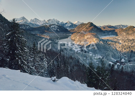 Breathtaking Snowy Mountain Landscape with Lake Near Neuschwanstein Castle in Germany at Dawn Breathtaking Snowy Mountain Landscape with Lake Near Neuschwanstein Castle in Germany at Dawn 128324840