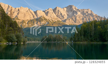 Scenic View of Eibsee Lake with Zugspitze Mountain at Sunset in Bavaria, Germany. Stunning Eibsee Lake with Zugspitze Reflection at Sunset in Bavaria, Germany. Tranquil Alpine Scene Captures the Scenic View of Eibsee Lake with Zugspitze Mountain at Sunset in Bavaria, Germany. Stunning Eibsee Lake with Zugspitze Reflection at Sunset in Bavaria, Germany. Tranquil Alpine Scene Captures the 128324855