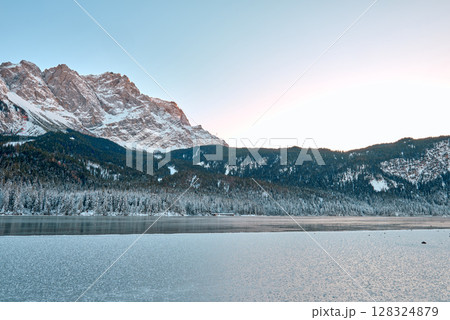 Breathtaking Alpine Winter Wonderland: Majestic Zugspitze Mountain Reflects in Frozen Eibsee Lake Amidst Snowy German Landscape Picturesque Ski Resort Nestled in Bavarian Forest Offers Stunning Breathtaking Alpine Winter Wonderland: Majestic Zugspitze Mountain Reflects in Frozen Eibsee Lake Amidst Snowy German Landscape Picturesque Ski Resort Nestled in Bavarian Forest Offers Stunning 128324879