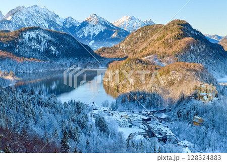 Breathtaking Snowy Mountain Landscape with Lake Near Neuschwanstein Castle in Germany at Dawn 128324883