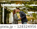 Young Cute Female Hugs Boyfriend. In Autumn Outdoor. Lovers Walking in Park. Attractive Funny Couple. Lovestory in Forest. Man and Woman. Cute Lovers in the Park. Family Concept. Happy Couple. 128324956