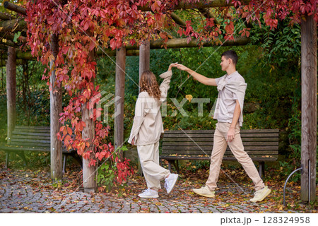 Young Cute Female Hugs Boyfriend. In Autumn Outdoor. Lovers Walking in Park. Attractive Funny Couple. Lovestory in Forest. Man and Woman. Cute Lovers in the Park. Family Concept. Happy Couple. 128324958