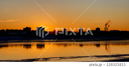 A beautiful orange sunset with a black silhouette of city buildings A beautiful orange sunset with a black silhouette of city buildings 128325811