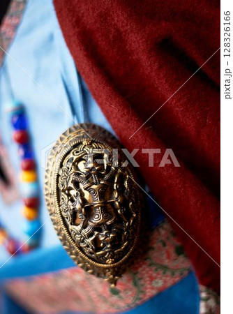 Decoration of clothes in the Slavic ancient style. Vikings. Multi-colored beads, simple fabrics of rich colors. Pastiche. Decoration of clothes in the Slavic ancient style. Vikings. Multi-colored beads, simple fabrics of rich colors. Pastiche. 128326166