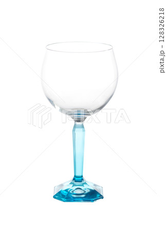 Elegant empty wine glass with faceted turquoise stem and base, isolated on a white background. Elegant empty wine glass with faceted turquoise stem and base, isolated on a white background. 128326218