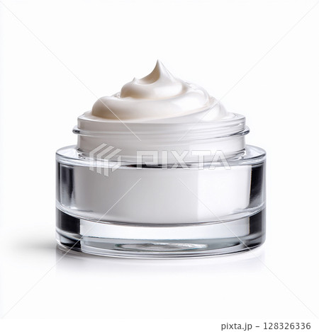 A swirl of thick, white cosmetic cream in a clear glass jar, symbolizing luxury skincare, beauty, and hydration. 128326336