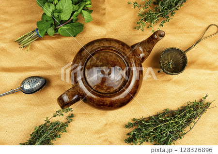 Glass teapot with herbal tea. 128326896
