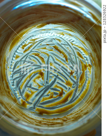 Empty jar with peanut butter residue, close-up full-frame view Empty jar with peanut butter residue, close-up full-frame view 128326922