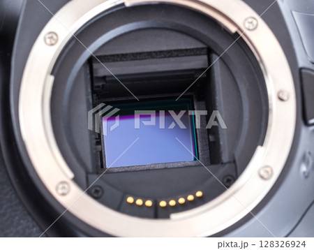 Close-up of a camera with exposed image sensor in studio setting 128326924