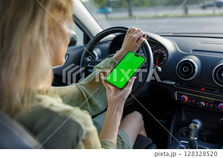 A Woman Using a Smartphone While Driving: Navigating the Car with Attention and Technology in a Modern World of Digital Connectivity and Responsibility 128328520