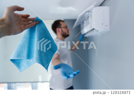 Professionally Maintaining Air Conditioning Units: The Importance of Regular Cleaning and Care for Optimal Performance and Longevity in Your Home Environment 128328871