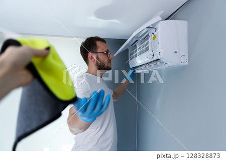 Professional Air Conditioner Maintenance: Ensuring Optimal Performance and Cleanliness in Home Cooling Systems with Proper Techniques and Tools for a Comfortable Environment 128328873