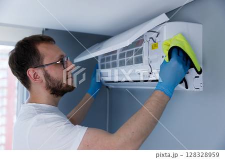 Expert Maintenance of Air Conditioning Units: A Detailed Look at a Professional Cleaning Process in a Modern Residential Setting 128328959