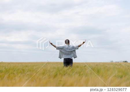Man Embracing Nature in a Wheat Field Under a Cloudy Sky, Capturing the Essence of Freedom and Serenity in the Great Outdoors Experience Man Embracing Nature in a Wheat Field Under a Cloudy Sky, Capturing the Essence of Freedom and Serenity in the Great Outdoors Experience 128329077