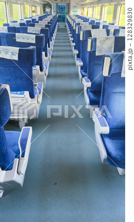 Spacious and Comfortable Train Interior with Blue Seating and Clean Aisles for a Relaxing Journey Experience in Modern Rail Travel Spacious and Comfortable Train Interior with Blue Seating and Clean Aisles for a Relaxing Journey Experience in Modern Rail Travel 128329830