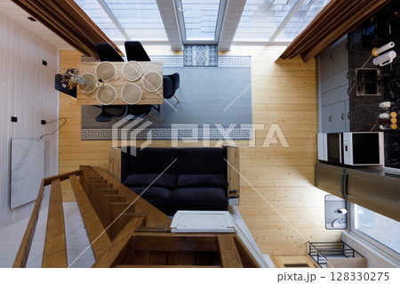 Stylishly Designed Open-Concept Living Area with Elegant Dining Table and Cozy Seating Arrangement in a Bright, Minimalist Home Space Featuring Modern Aesthetics 128330275