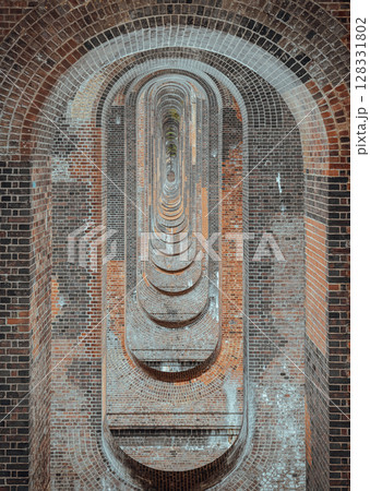 The semi-circular arches vaulting supporting traditional red brick piers with smooth limestone. 128331802
