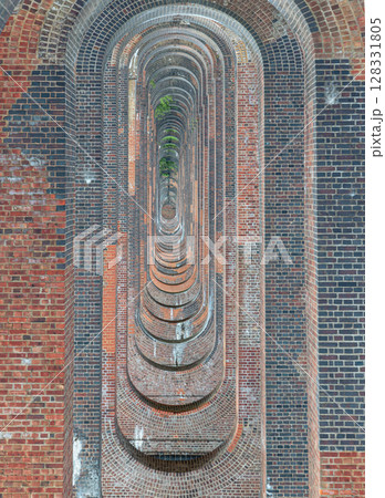 The semi-circular arches vaulting supporting brick piers, composed of traditional red bricks topped with smooth limestone 128331805
