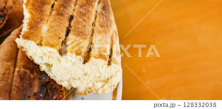 Bits of delicious toasted flatbread, on tabletop, space for text on right, banner 128332038