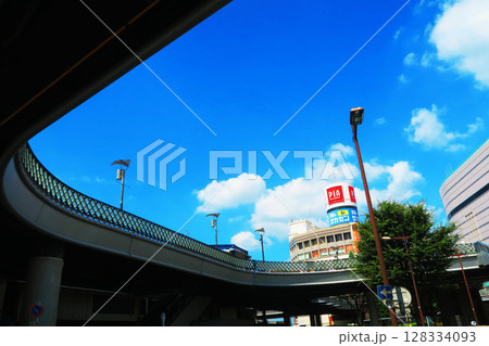 埼玉県川口市の川口駅東口駅前のペデストリアンデッキの下から見上げた青空と駅前のビル群の風景 128334093