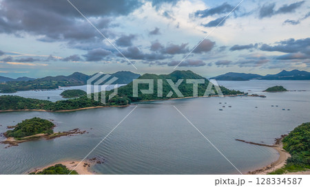 July 5 2025 Scenic View of Green Islands in a Beautiful Blue Sea by Mountains 128334587